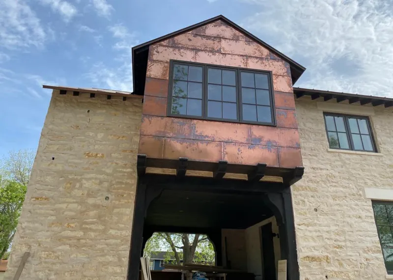 Copper metal panel facade on a stone building for Skylight Installation in Ecorse