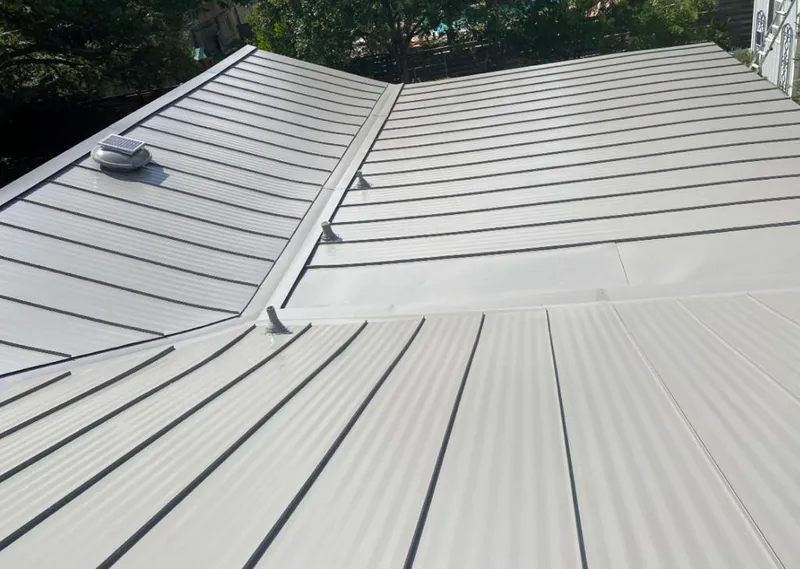 Solar attic fan installed on a metal roof for Roof Ventilation in Ecorse